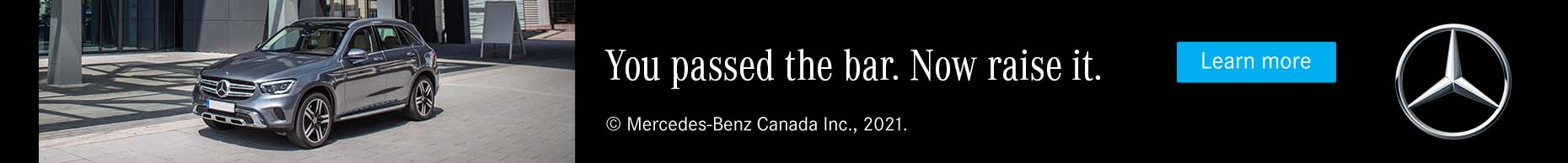 Mercedes-Benz advertisement featuring a silver SUV parked outside a modern building, with the slogan 'You passed the bar. Now raise it.
